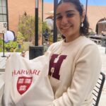 Lucia Lopez is headed to Harvard and shows some of the college's spirit wear.