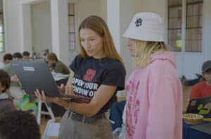 Adult and high school student collaborate on college application.