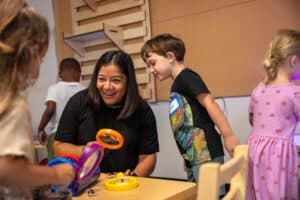 HTH CEO Dr. Diana Cornejo-Sanchez shares a moment with transitional kindergarten students.
