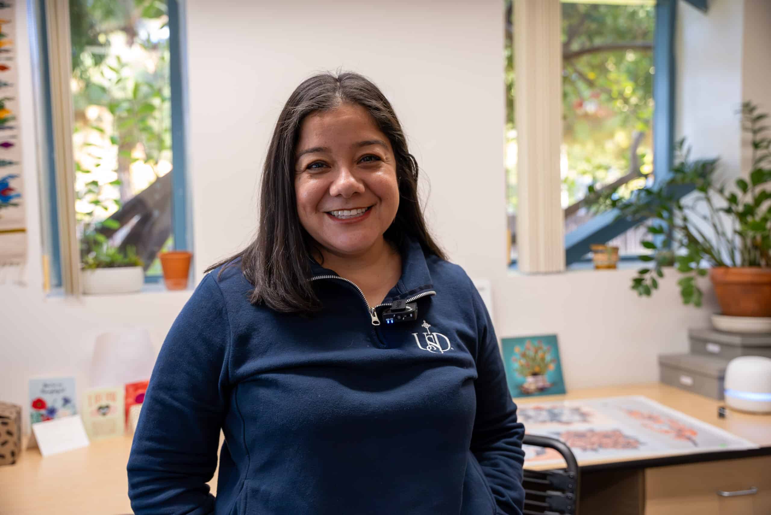 Dr. Diana Cornejo-Sanchez stands in her office, smiling.
