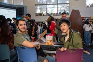A student from High Tech High International and a student from Taiwan sit together at Exhibition.