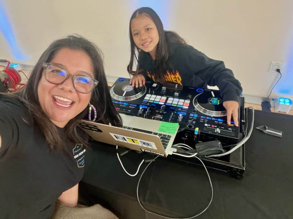 CEO Diana Cornejo-Sanchez shares a joyful moment with a High Tech Elementary Explorer student: DJ Mai.