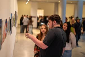 Student shares information at an exhibition.