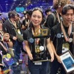 HTH San Diego robotics student holds the winning hardware.